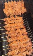 Grilled beef suya sticks fresh off the charcoal grill